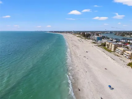 a view of a lake with beach and city