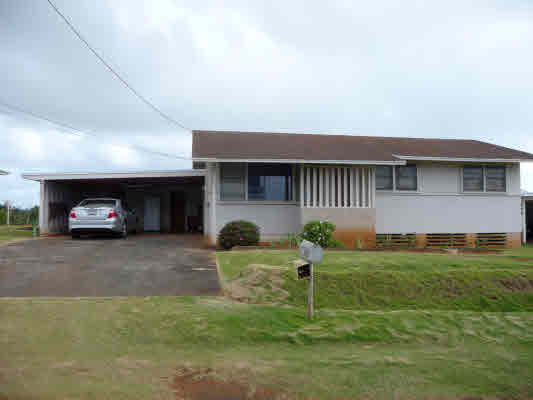 4866 Yamanoha Road Kapaa, HI 96746 - Photo 1 of 9 a front view of a house with a yard and garage