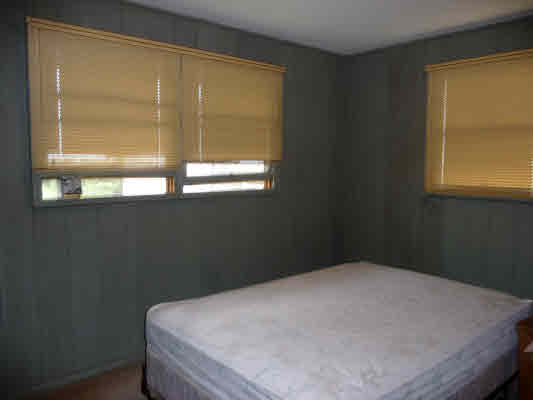 4866 Yamanoha Road Kapaa, HI 96746 - Photo 8 of 9 a bed sitting in a bedroom next to a window