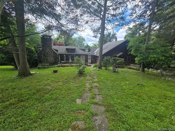 a view of a house with a yard porch and sitting area