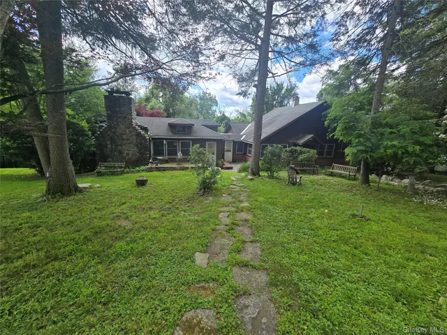 a view of a house with a yard porch and sitting area