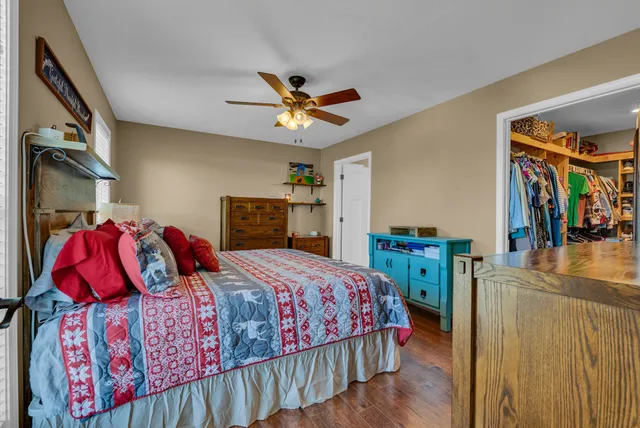 a bedroom with a bed and a chandelier