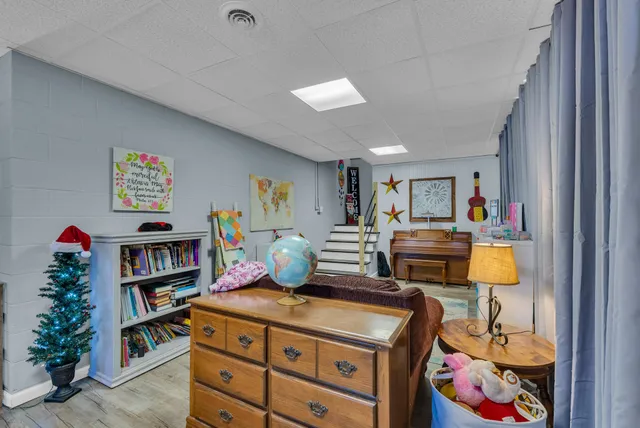 a bedroom with furniture and a book shelf