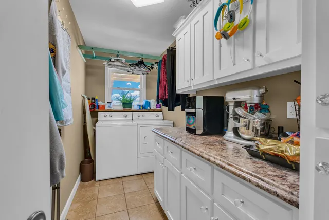 a kitchen with granite countertop a white refrigerator oven a sink and dishwasher