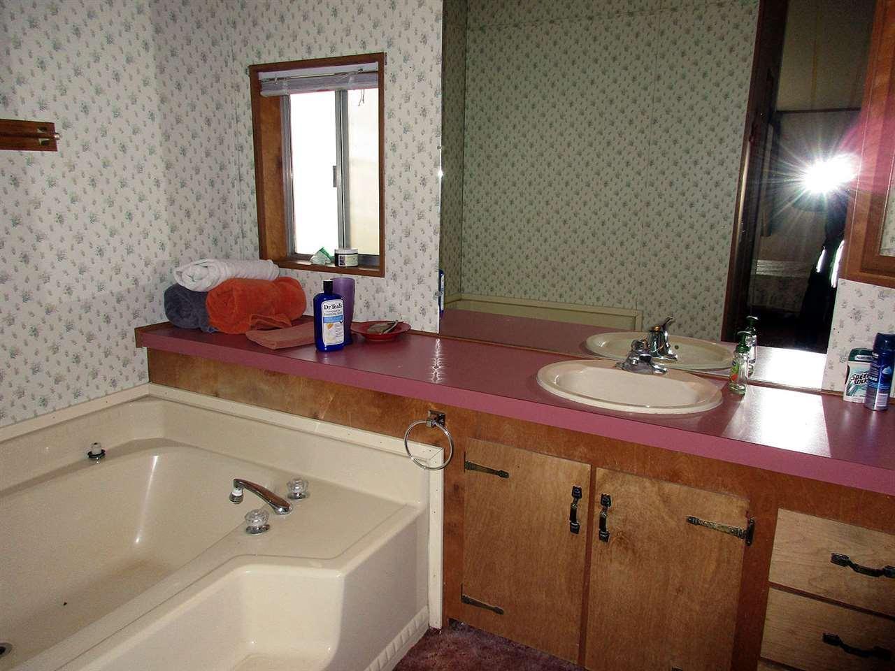 10901 Crystal Springs Road Klamath Falls, OR 97603 - Photo 9 of 21 a bathroom with a double vanity sink and a mirror