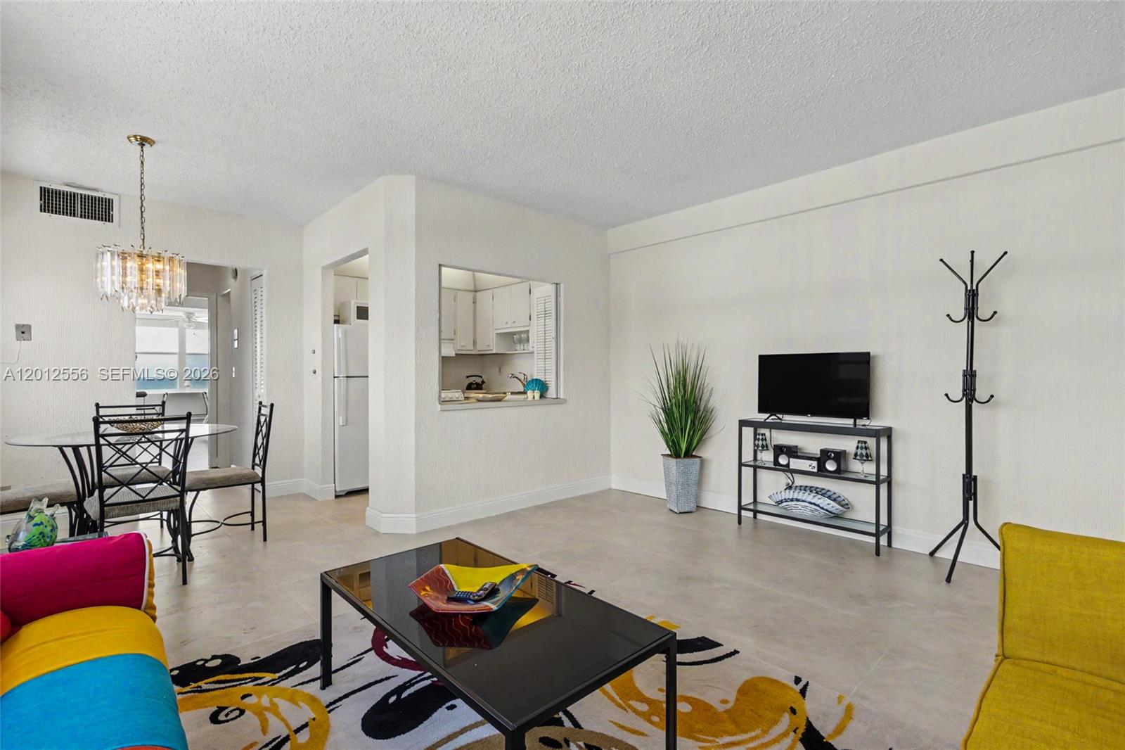 1801 South Surf Road, Unit 4A Hollywood, FL 33019 - Photo 13 of 24 a living room with furniture and a flat screen tv
