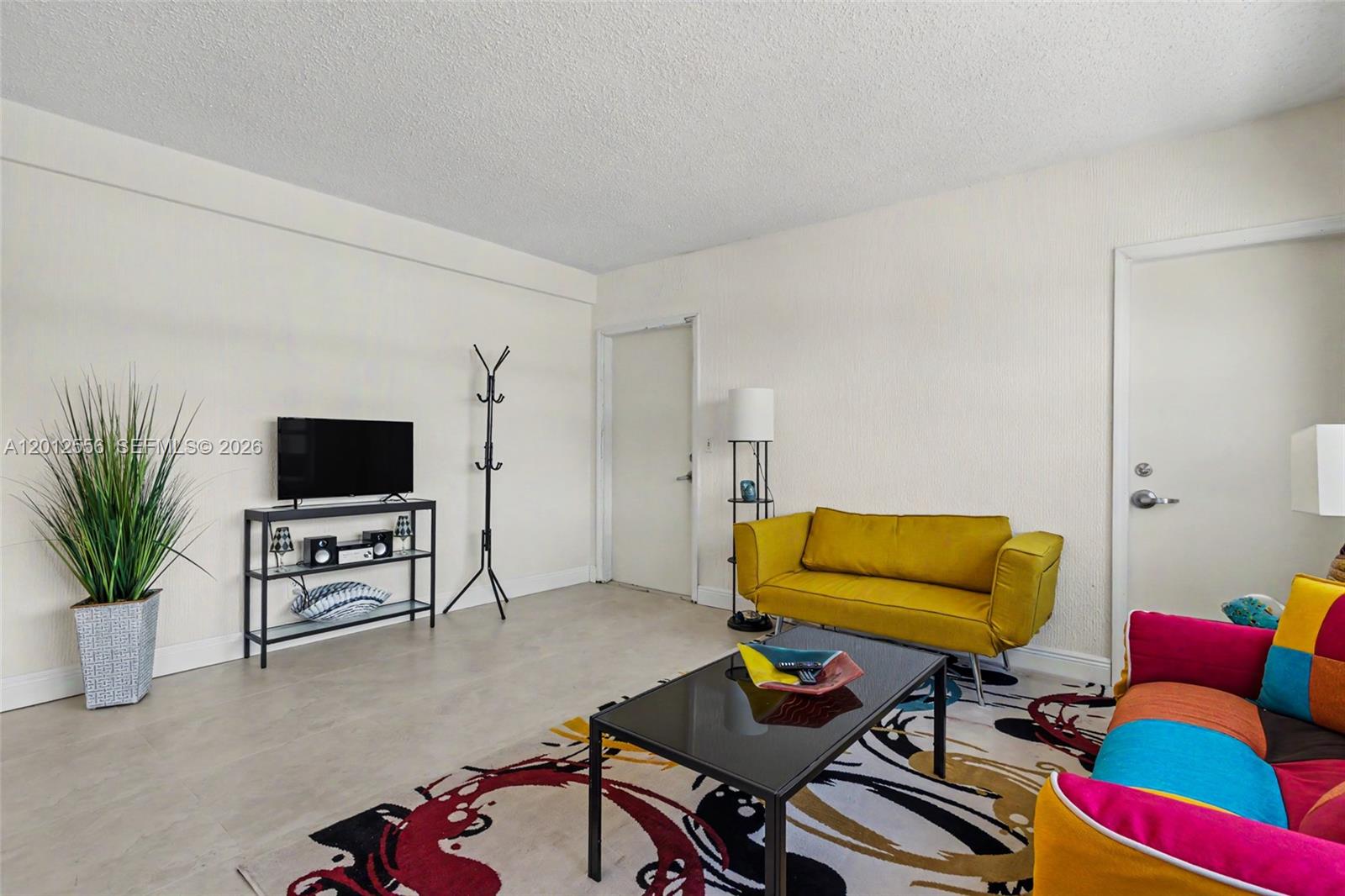 1801 South Surf Road, Unit 4A Hollywood, FL 33019 - Photo 16 of 24 a living room with furniture and a flat screen tv