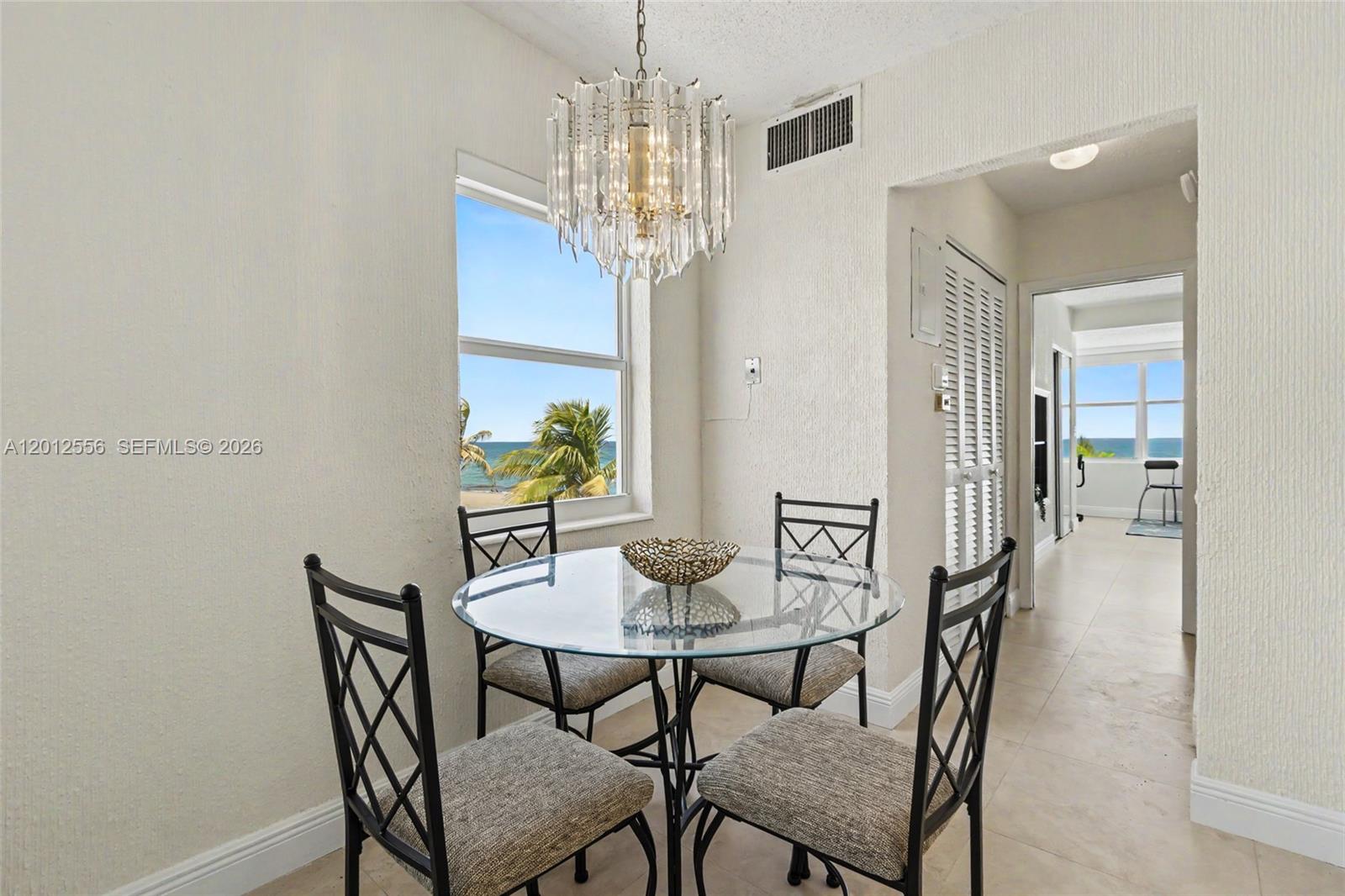 1801 South Surf Road, Unit 4A Hollywood, FL 33019 - Photo 17 of 24 a view of a dining room with furniture and chandelier