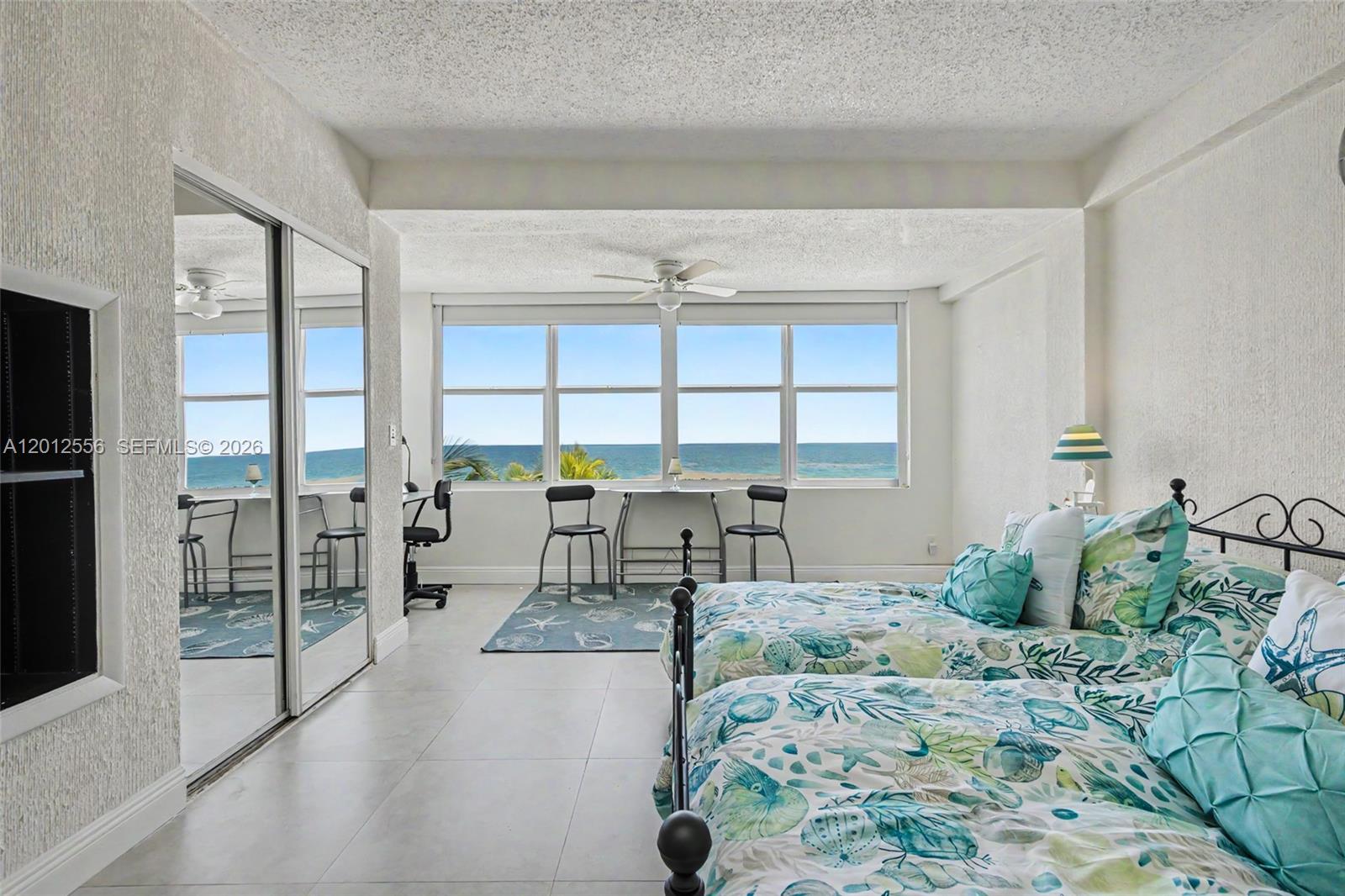 1801 South Surf Road, Unit 4A Hollywood, FL 33019 - Photo 22 of 24 a bedroom with a bed and large window with balcony view