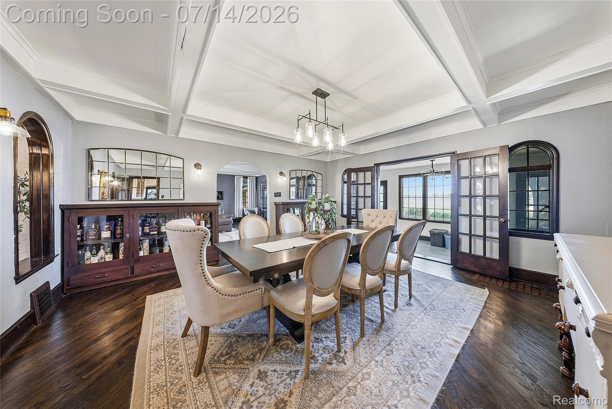 18460 Meridian Road Grosse Ile, MI 48138 - Photo 20 of 50 Dining space featuring wood-finish flooring, coffered ceiling, and a modern chandelier