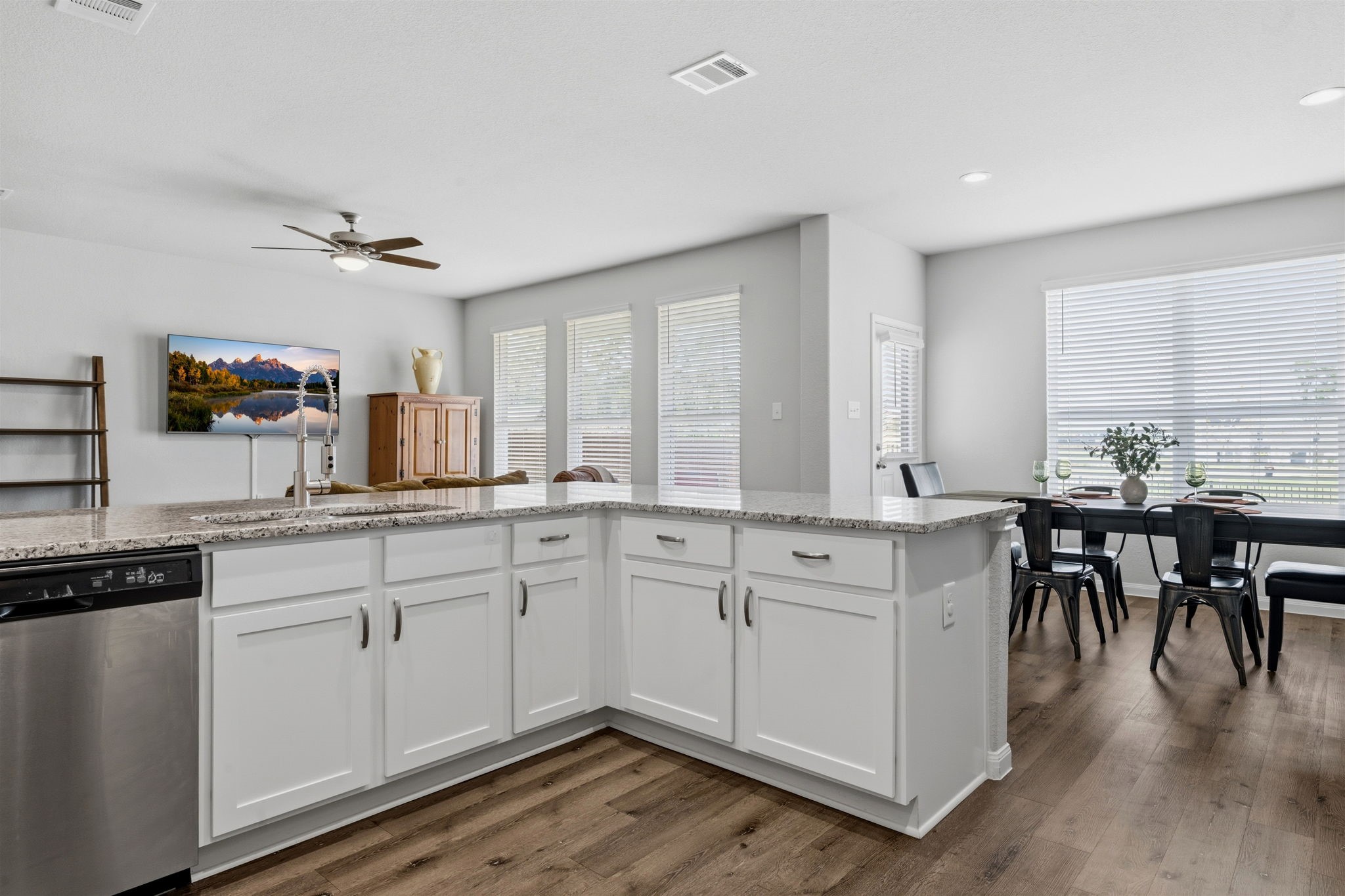 2542 Sturgeon Way Conroe, TX 77384 - Photo 13 of 40 a open kitchen with white cabinets and wooden floor