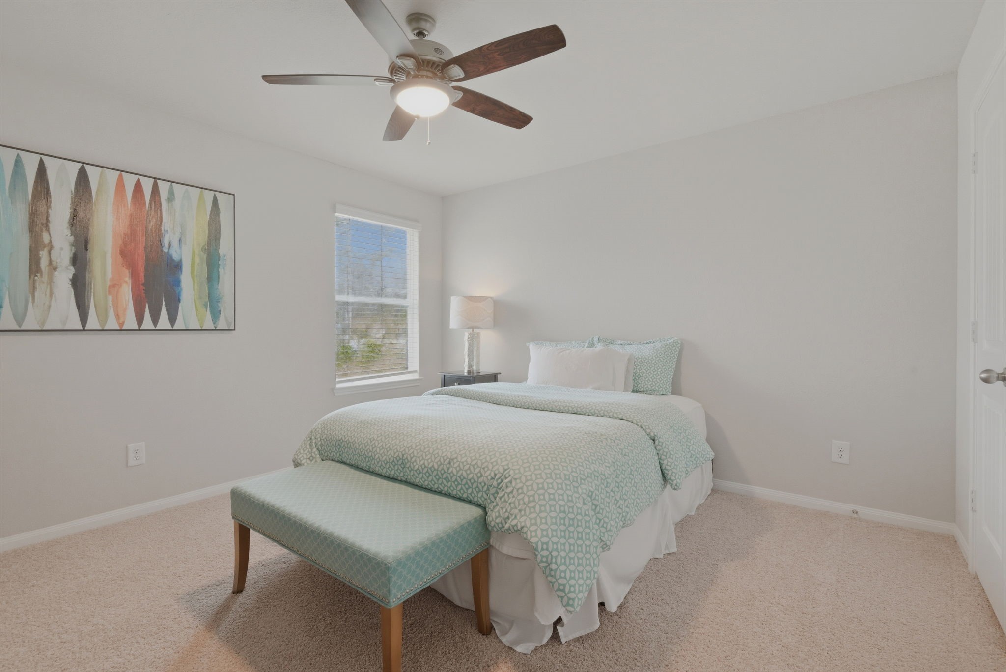 2542 Sturgeon Way Conroe, TX 77384 - Photo 17 of 40 a bedroom with a bed and a painting on the wall