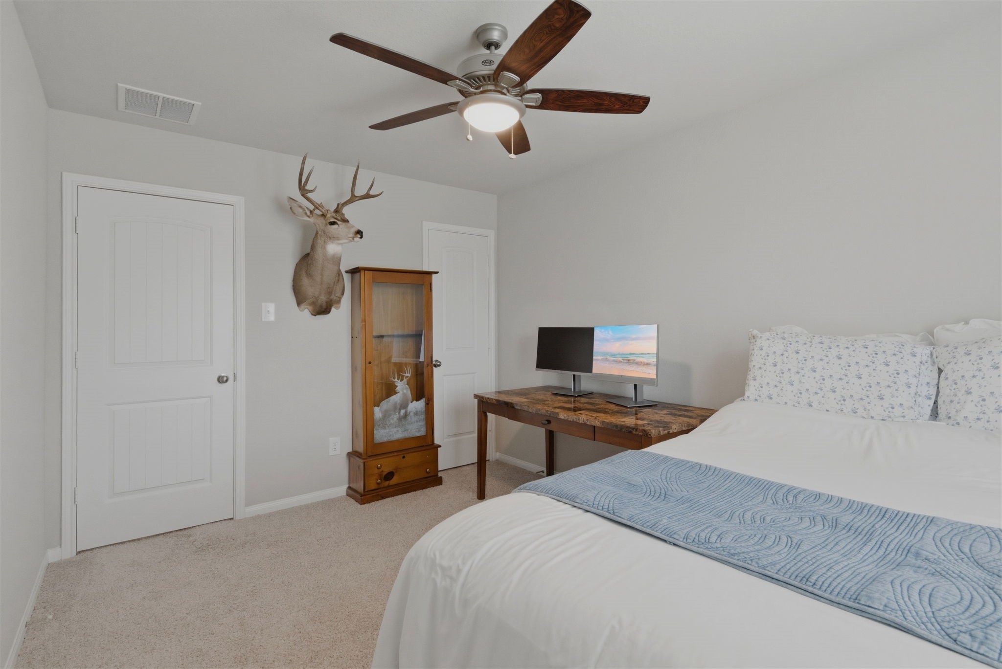 2542 Sturgeon Way Conroe, TX 77384 - Photo 20 of 40 a bedroom with a bed and a chandelier