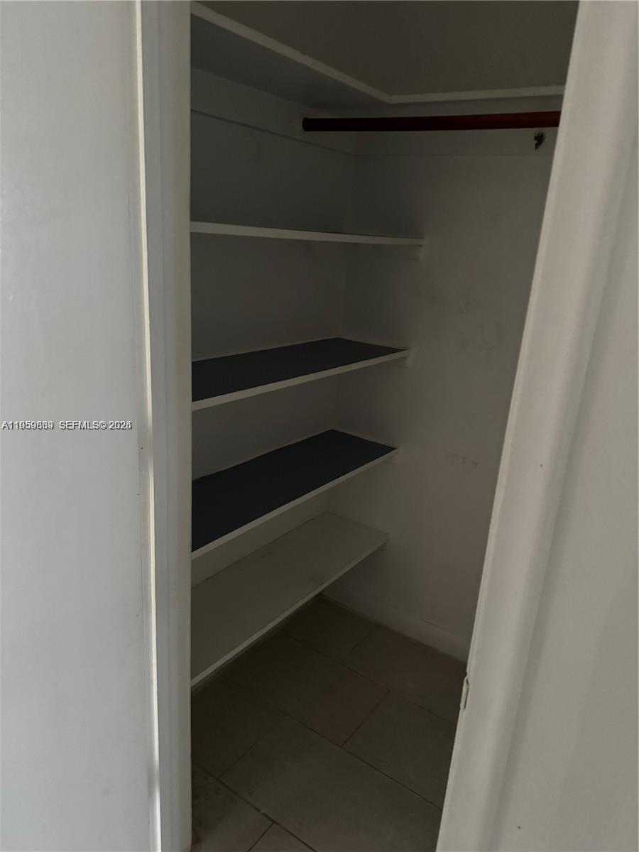 285 Northeast 191st Street, Unit 2907 Miami, FL 33179 - Photo 11 of 13 a view of walk in closet with empty racks