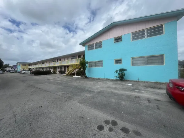 a view of a garden with a building in the background