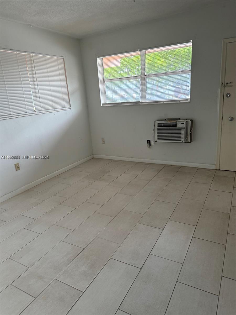 285 Northeast 191st Street, Unit 2907 Miami, FL 33179 - Photo 6 of 13 an empty room with windows