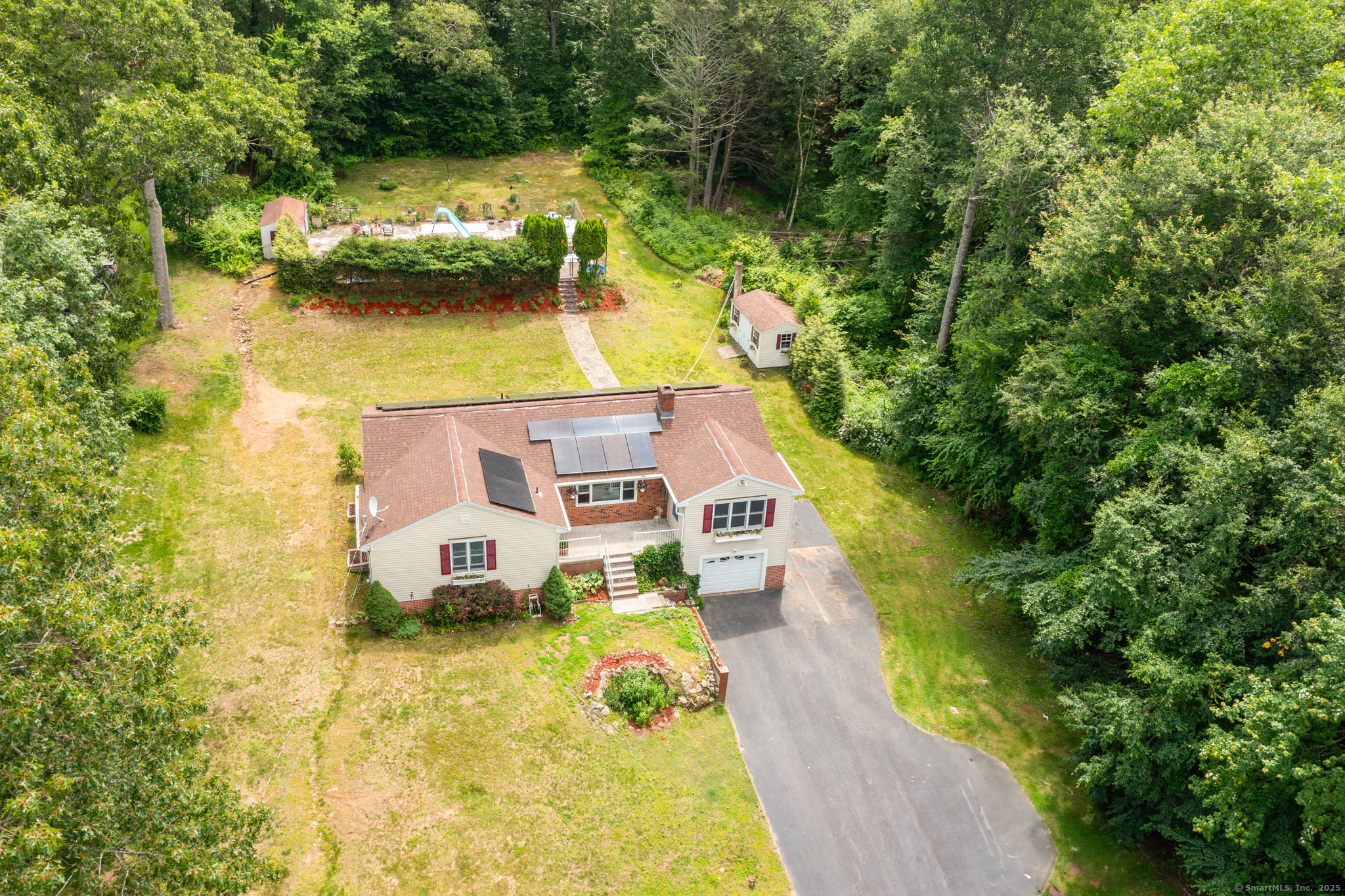 56 Park Road Colchester, CT 06415 - Photo 1 of 1 a aerial view of a house with swimming pool and large trees