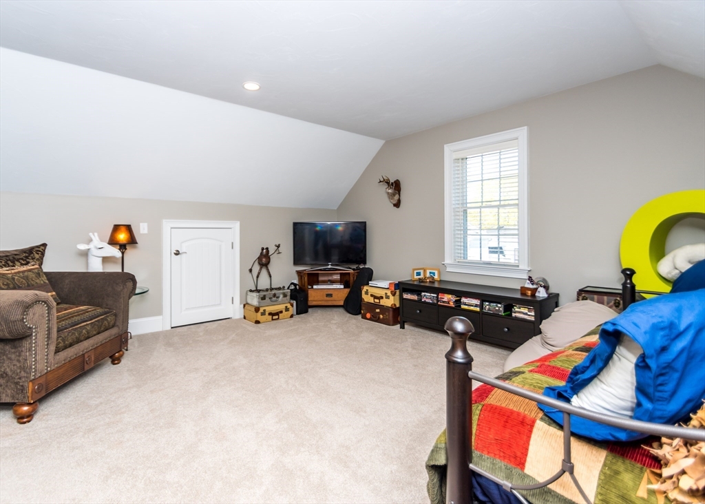128 Church Street, Unit 2 Waltham, MA 02452 - Photo 33 of 41 a bedroom with furniture and a bed