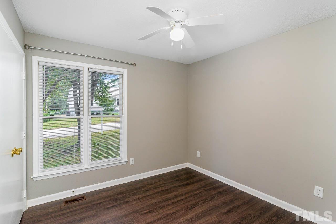 4209 Traders Dock Court Raleigh, NC 27616 - Photo 13 of 17 a view of an empty room with wooden floor and a window
