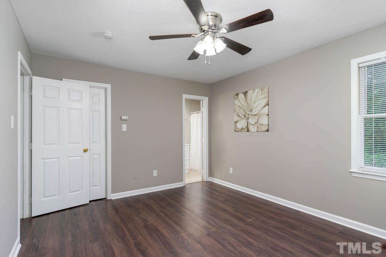 4209 Traders Dock Court Raleigh, NC 27616 - Photo 9 of 17 an empty room with wooden floor ceiling fan and windows