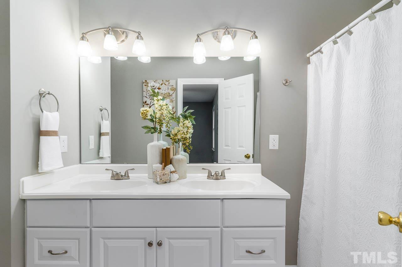 4209 Traders Dock Court Raleigh, NC 27616 - Photo 10 of 17 a bathroom with a sink double vanity and a mirror