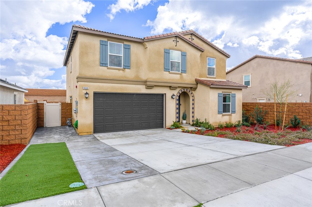 9668 Tuco Lane Riverside, CA 92508 - Photo 1 of 1 a front view of a house with a yard and garage