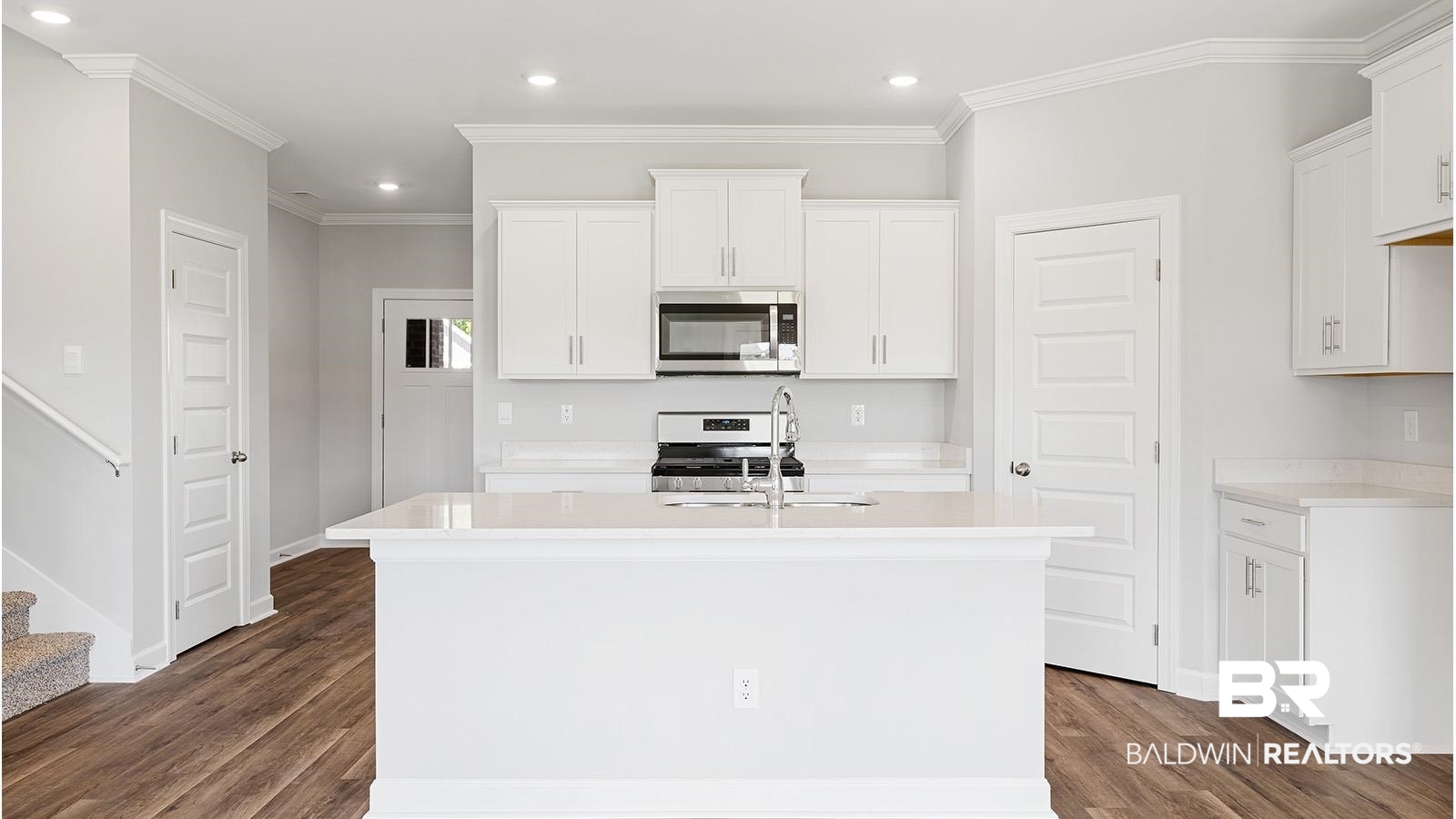 30567 Asheville Road Daphne, AL 36527 - Photo 5 of 29 Kitchen with stainless steel appliances, white cabinetry, recessed lighting, dark wood-type flooring, and an island with sink