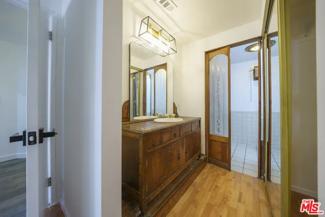 a bathroom with a mirror and a shower