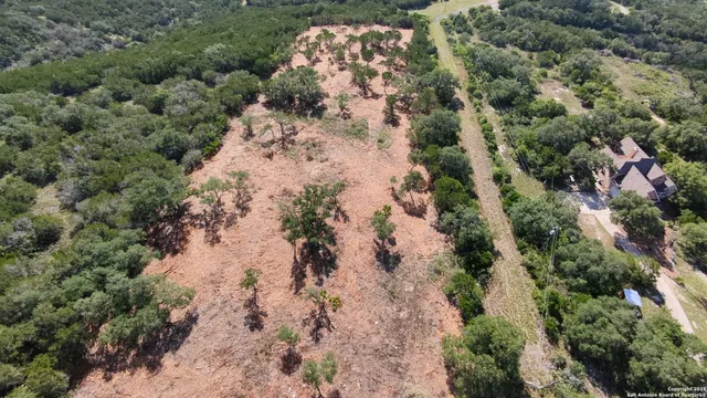 an aerial view of a houses with a yard