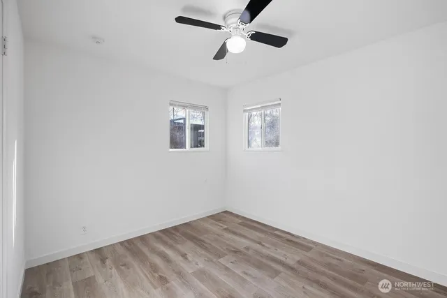 wooden floor in an empty room with a window