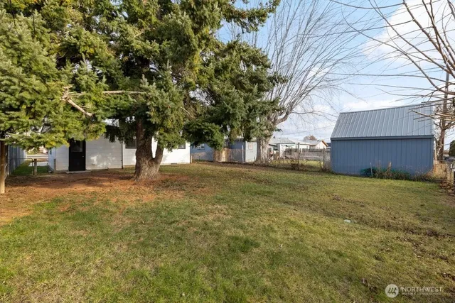 a house view with a trees in the background