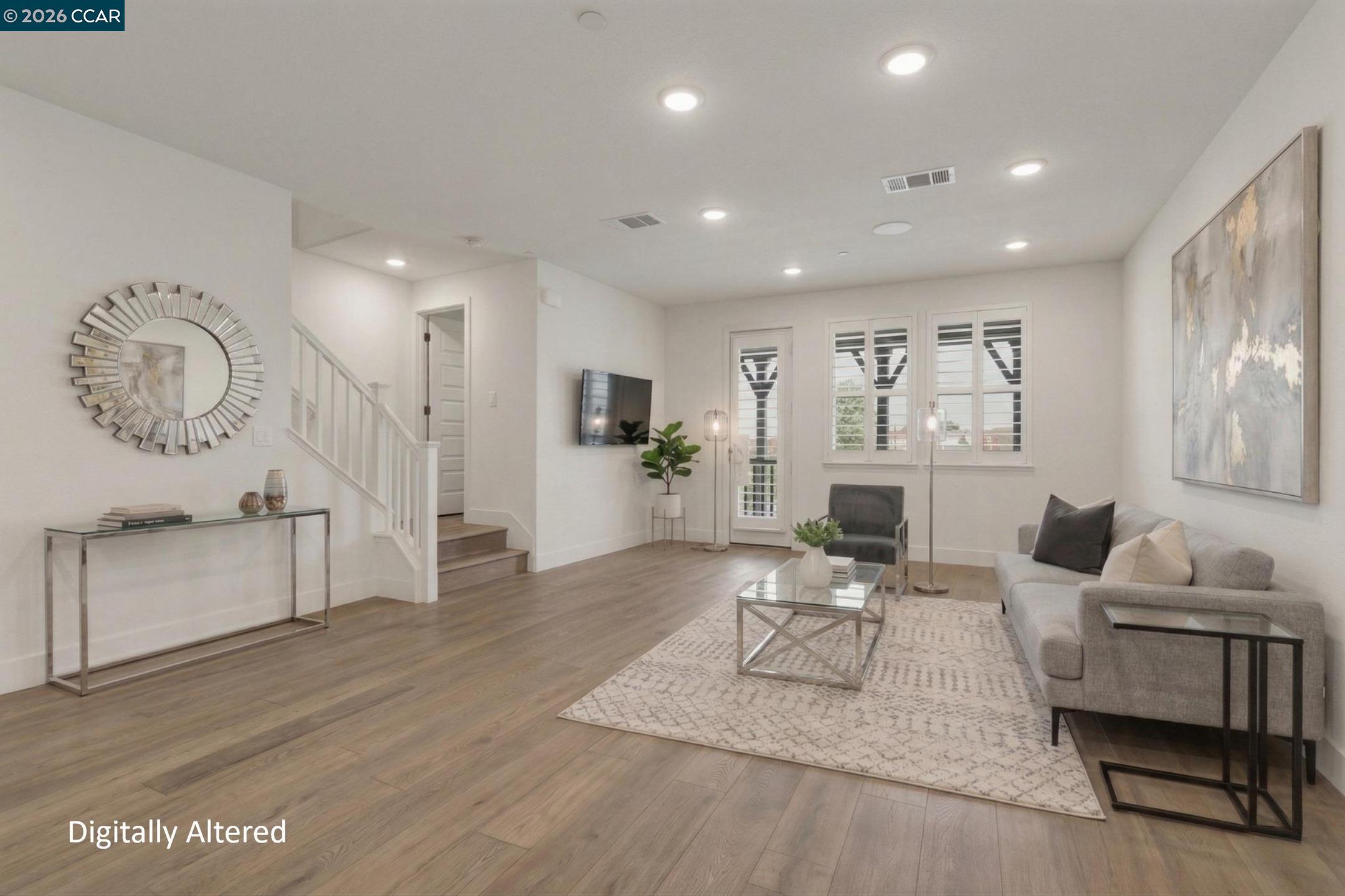 2737 5th Street Alameda, CA 94501 - Photo 11 of 37 a living room with furniture a wooden floor and a fireplace