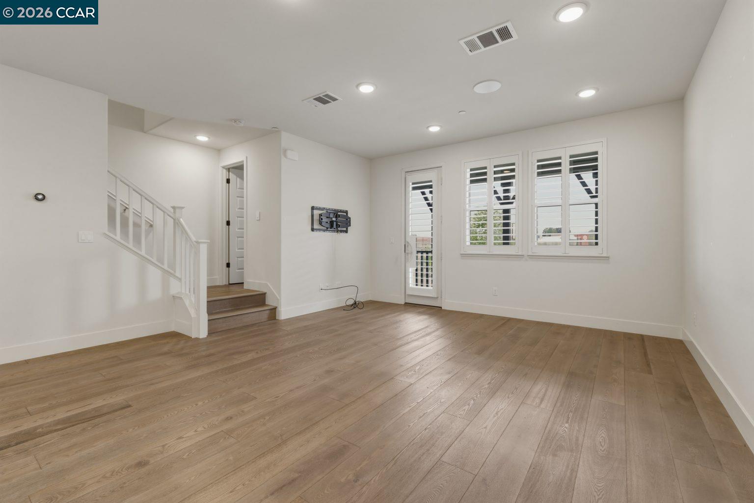2737 5th Street Alameda, CA 94501 - Photo 12 of 37 an empty room with wooden floor and windows