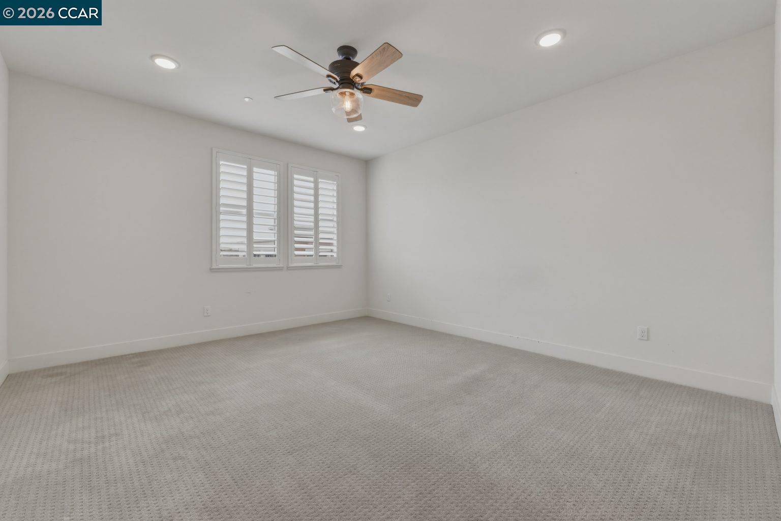 2737 5th Street Alameda, CA 94501 - Photo 20 of 37 an empty room with a chandelier fan and windows