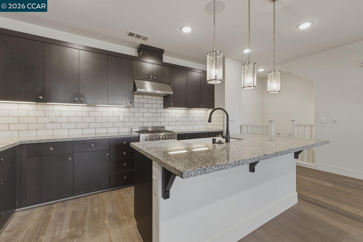 2737 5th Street Alameda, CA 94501 - Photo 4 of 37 a kitchen with stainless steel appliances granite countertop a sink a counter space and cabinets