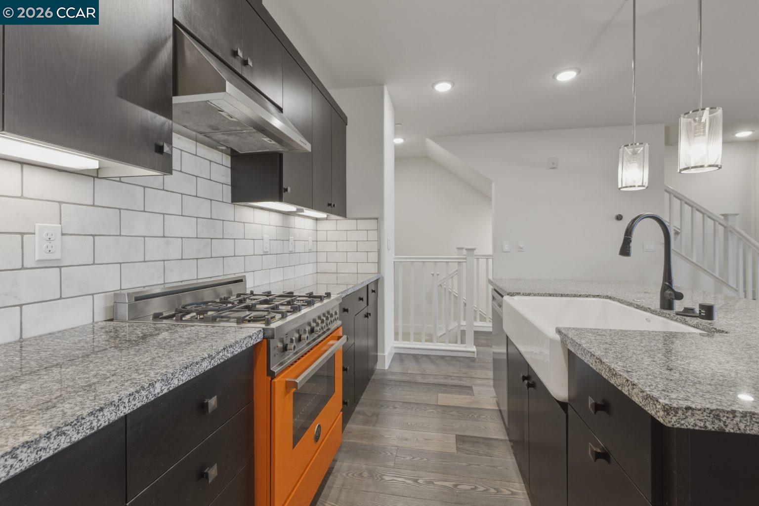 2737 5th Street Alameda, CA 94501 - Photo 5 of 37 a kitchen with stainless steel appliances granite countertop a sink stove and cabinets