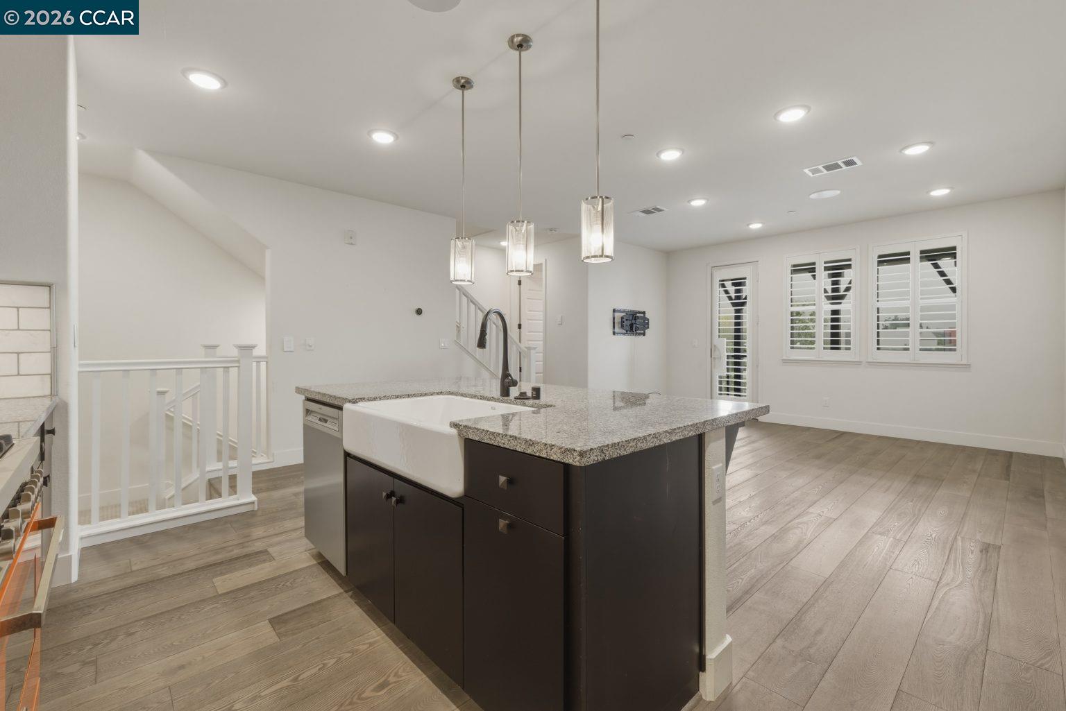 2737 5th Street Alameda, CA 94501 - Photo 6 of 37 a kitchen with a sink chandelier and wooden floor