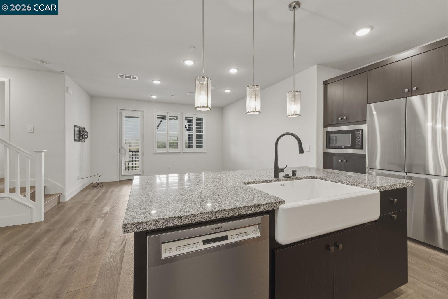 2737 5th Street Alameda, CA 94501 - Photo 9 of 37 a kitchen with kitchen island stainless steel appliances a sink and a refrigerator