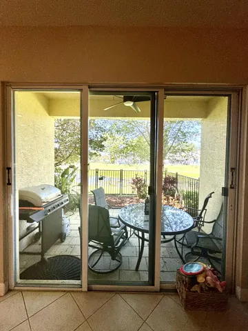 a room with lots of chairs and view of living room
