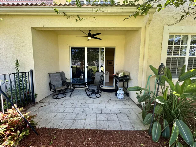 a view of a lounge chairs in the patio next to a yard