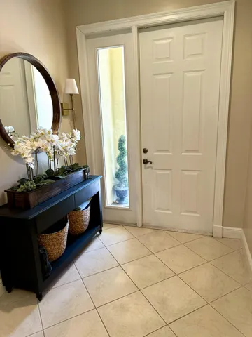 a spacious bathroom with a mirror and a sink