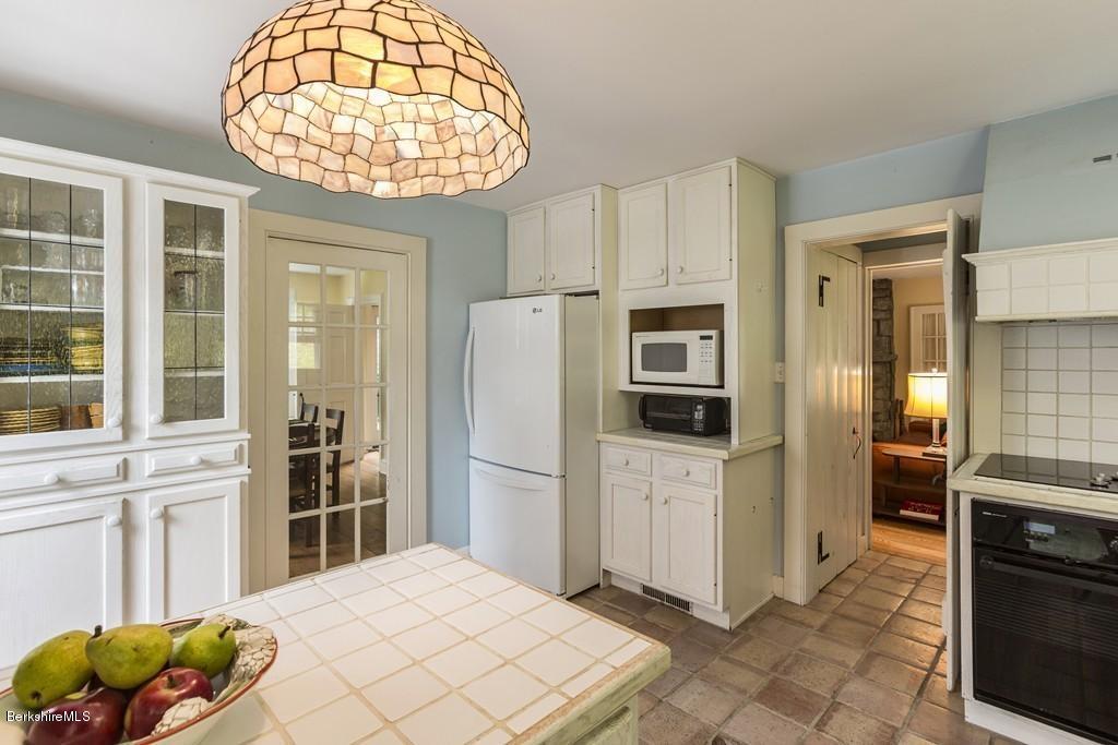 635 Reservoir Road Otis, MA 01029 - Photo 15 of 30 a kitchen with stainless steel appliances a refrigerator and a stove top oven
