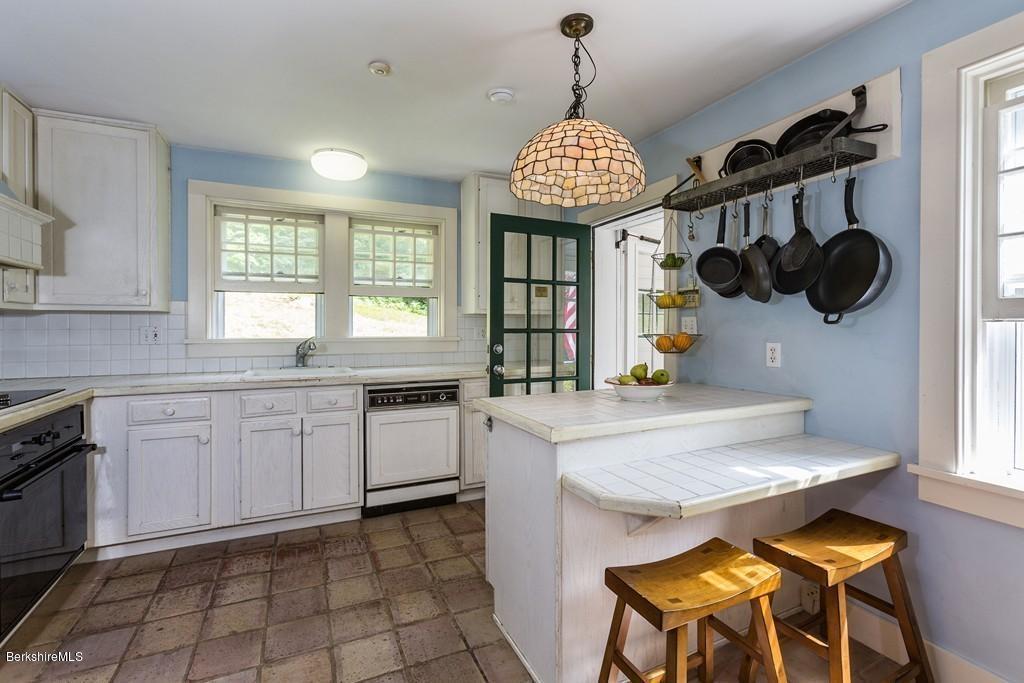 635 Reservoir Road Otis, MA 01029 - Photo 16 of 30 a kitchen with stainless steel appliances granite countertop a sink a stove and a wooden floors