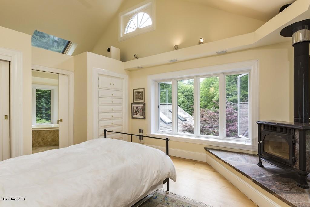 635 Reservoir Road Otis, MA 01029 - Photo 19 of 30 a bedroom with a bed and a large window