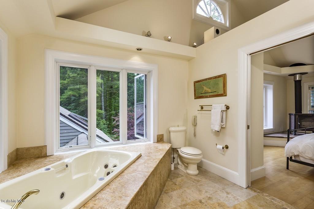 635 Reservoir Road Otis, MA 01029 - Photo 22 of 30 a bathroom with a tub sink toilet and mirror