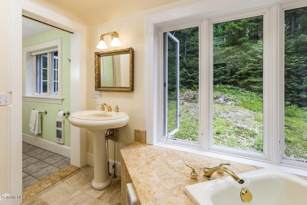 635 Reservoir Road Otis, MA 01029 - Photo 23 of 30 a bathroom with a sink and a bathtub