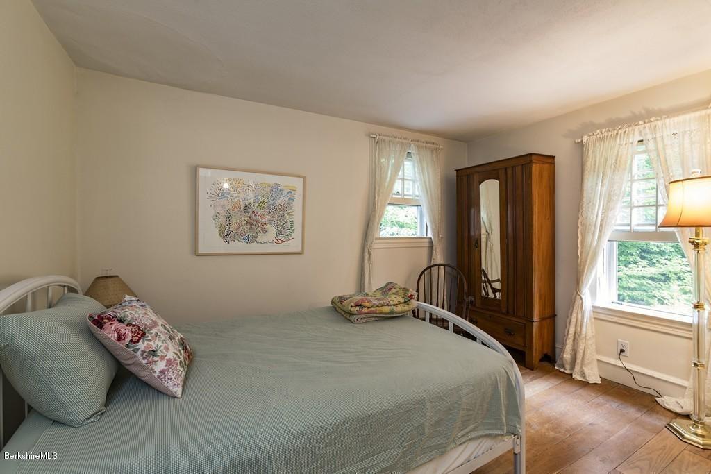 635 Reservoir Road Otis, MA 01029 - Photo 24 of 30 a bedroom with a bed and wooden floor