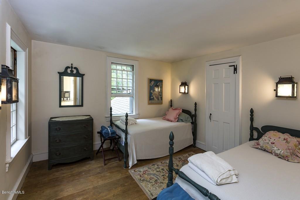635 Reservoir Road Otis, MA 01029 - Photo 25 of 30 a bedroom with a bed and wooden floor