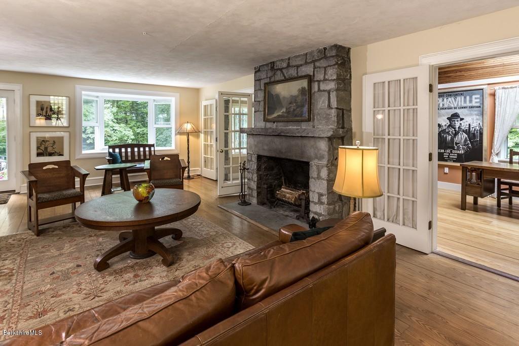 635 Reservoir Road Otis, MA 01029 - Photo 4 of 30 a living room with furniture and a fireplace