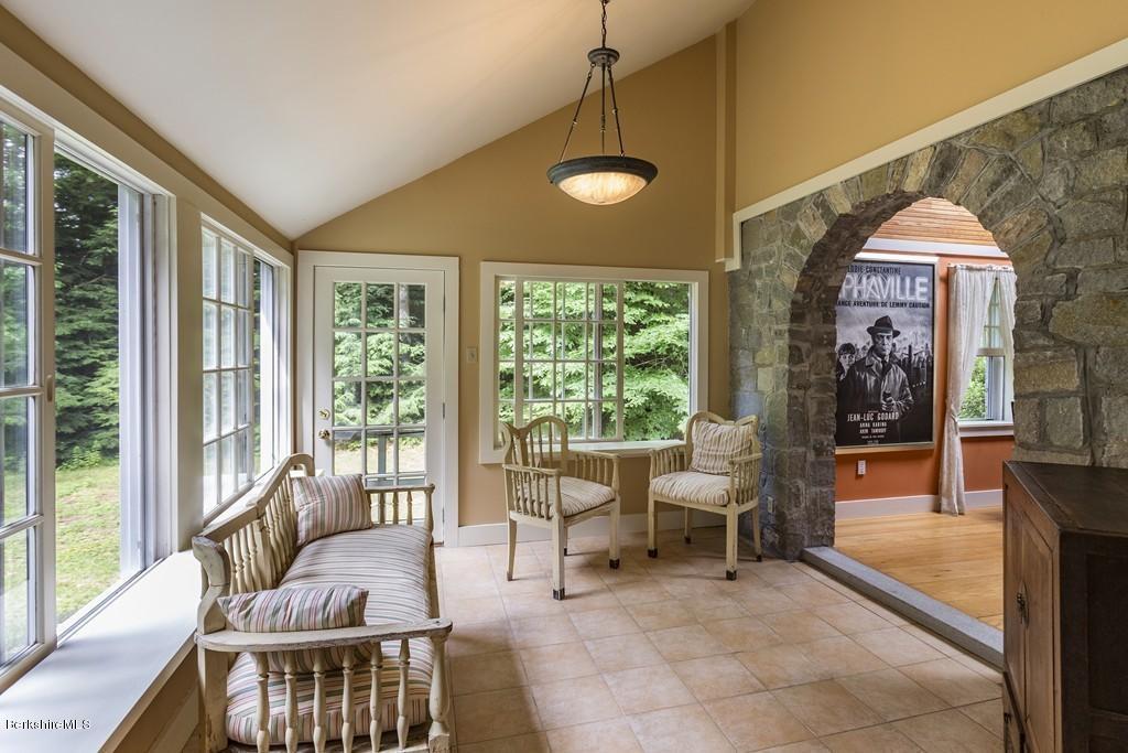 635 Reservoir Road Otis, MA 01029 - Photo 7 of 30 a dining room with furniture and large windows